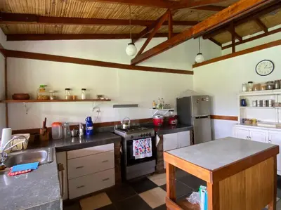 a kitchen with a sink and a stove top oven at Casa de campo con piscina en Asia in Asia