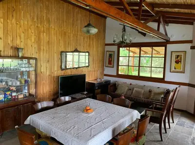 a dining room with a table and a couch at Casa de campo con piscina en Asia in Asia
