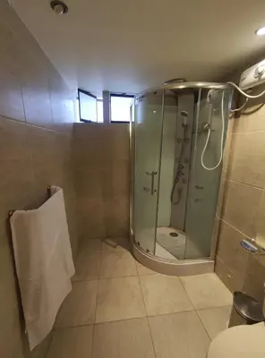 a bathroom with a shower with a large mirror at Inti Llaqta Hotel & Suites in Lima
