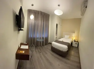 a hotel room with a bed and a television at LimaQ Hotel in Lima