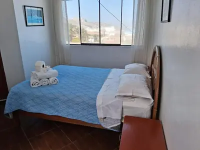 a small bed in a room with a window at HOTEL CHORRILLOS BEACH in Barranca
