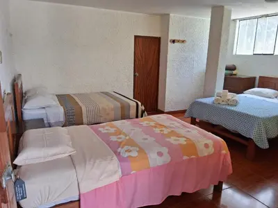 a hotel room with two beds and a table at HOTEL CHORRILLOS BEACH in Barranca