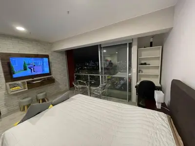 a bedroom with a large white bed and a tv at Beautiful loft at heart of Lima in Lima