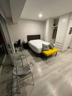 a bedroom with a bed and a table and chairs at Beautiful loft at heart of Lima in Lima