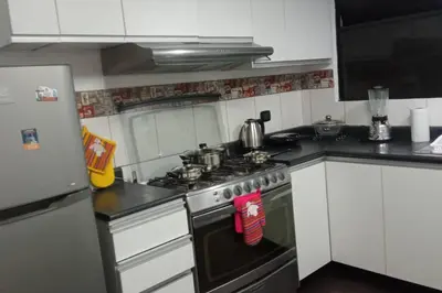 a kitchen with a stove with pots and pans on it at A beautiful place in the heart of Miraflores in Lima