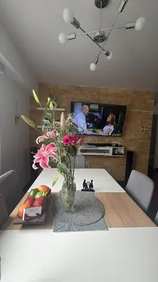 a vase of flowers on a table in a living room at A beautiful place in the heart of Miraflores in Lima