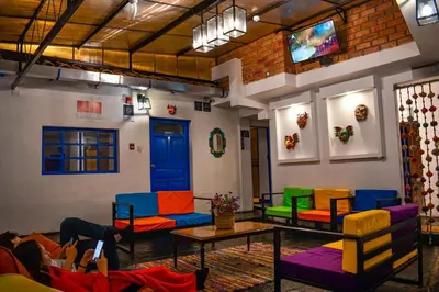 a room with colorful chairs and a table at Saqray Hostel in Cusco
