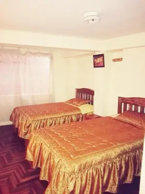 a room with two beds in a room at Euro Hostal in Cusco