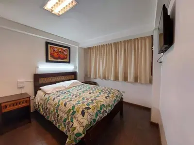 a bedroom with a bed and a television in it at Mirador de la Ñusta in Cusco