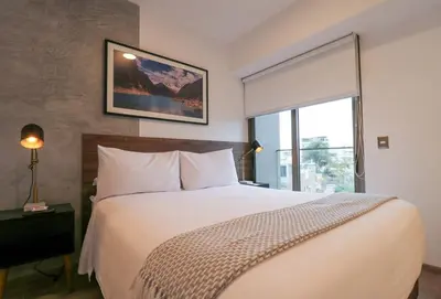 a bedroom with a large bed and a window at The Modern by Wynwood House in Lima