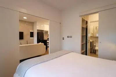 a bedroom with a bed and a tub and a bathroom at The Modern by Wynwood House in Lima