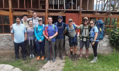 a group of people posing for a picture in front of a building at Refugio de Mery Lucmabamba in Sahuayacu