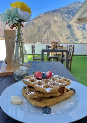 a stack of pancakes on a plate on a table at Hotel Sol de Canta in Canta