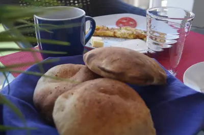 a table with a plate of food and a cup of coffee at CasaHotel El Tambo Huancayo in Huancayo
