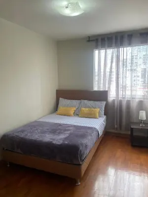 a bedroom with a bed and a large window at Miraflores Moonlight in Lima