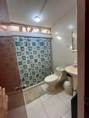 a bathroom with a toilet and a sink at Harmony Inn Miraflores in Lima