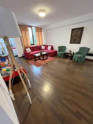 a living room with a red couch and green chairs at Harmony Inn Miraflores in Lima