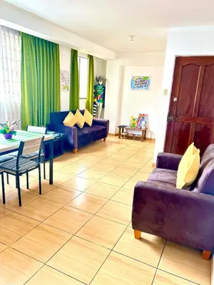 a living room with a couch and a table at V Habitación Miraflores City in Lima