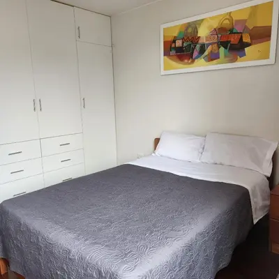 a bedroom with a bed and a painting on the wall at Casa Cultura in Lima