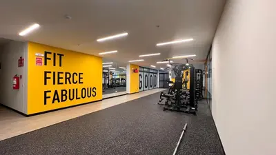 a gym with a large yellow sign on the wall at Apartament Social Tree 907 in Lima