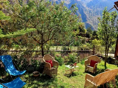a group of chairs and a table in a yard at Hotel Humantay lodge Ollantaytambo in Ollantaytambo