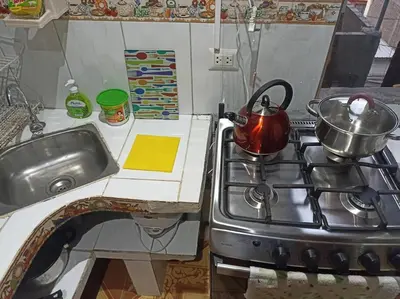 a kitchen with a stove with a tea kettle on it at Mi Casa Bonita con baño privado y ducha caliente in Lima