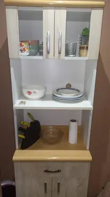 a cabinet with plates and dishes on it at Mi Casa Bonita con baño privado y ducha caliente in Lima