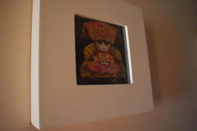 a picture of a doll hanging on a wall at ROOM Lima House centro in Lima