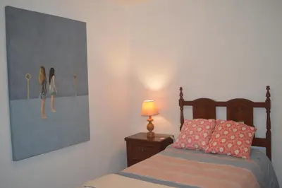 a bedroom with a bed and a picture of girls on the wall at ROOM Lima House centro in Lima