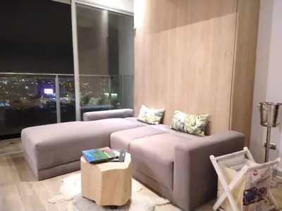 a living room with a couch and a large window at Barranco landscape suite boardwalk in Lima