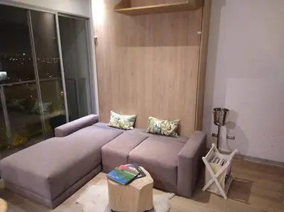 a living room with a couch and a chair at Barranco landscape suite boardwalk in Lima