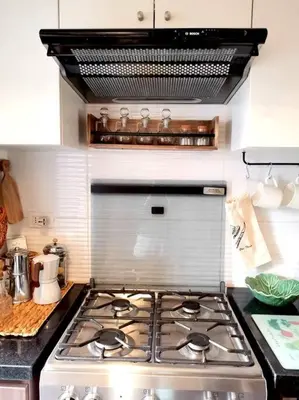 a kitchen with a stove top oven in a kitchen at departamento encantador céntrico con balcon in Lima