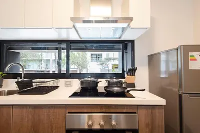 a kitchen with two pots and pans on a stove at Stunning Modern 1BD Apartment in Barranco in Lima