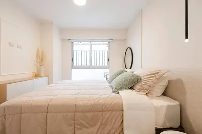 a bedroom with a large bed and a window at Stunning Modern 1BD Apartment in Barranco in Lima