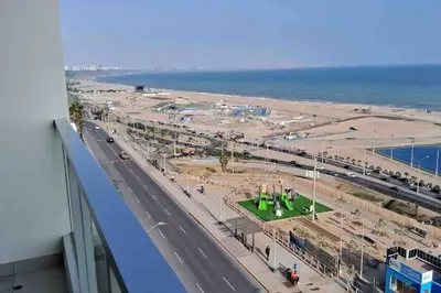 an aerial view of a beach and a road at apartamento de estreno con balcón frente al mar. in Lima