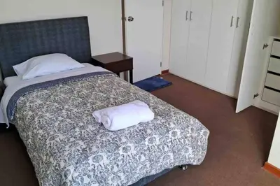 a bedroom with a bed with two towels on it at apartamento de estreno con balcón frente al mar. in Lima