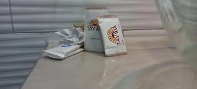 a counter with a bottle of milk and a toothpaste at TAYWA HOTEL in Machu Picchu