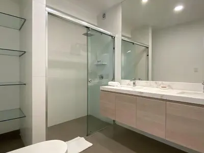 a bathroom with a glass shower and a toilet at Sky Balta in Miraflores by Wynwood House in Lima