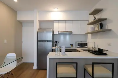 a kitchen with a stainless steel refrigerator and a counter at Sky Balta in Miraflores by Wynwood House in Lima