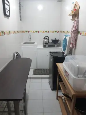 a small kitchen with a sink and a table at El Valle - Lunahuaná in Lunahuaná