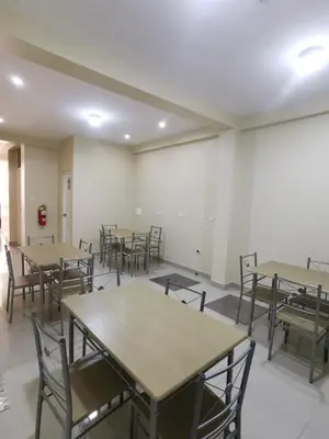 an empty room with tables and chairs in it at Hotel Sol de Marcona in San Juan de Marcona