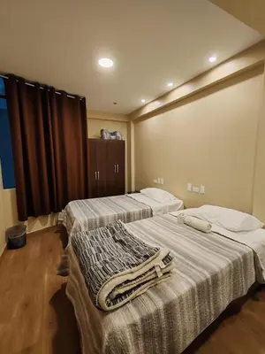 a room with two beds with towels on them at Hotel Sol de Marcona in San Juan de Marcona
