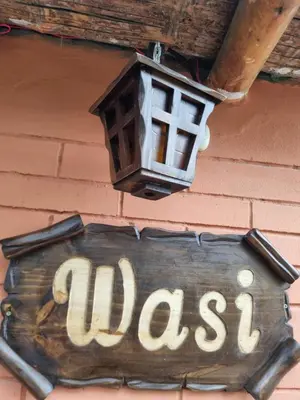 a sign on a building with a street sign and a lamp at Bungalows Payancas de Tato in Barranca