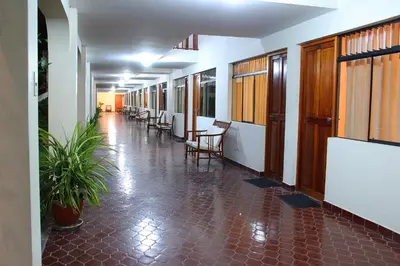 a hallway with chairs and tables in a building at Hotel Villa de Valverde in Ica