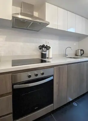 a kitchen with a stove and a sink at Silvia's New Spacious Patio Pad in Lima