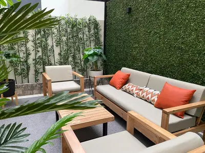 a patio with a couch and chairs and plants at Silvia's New Spacious Patio Pad in Lima