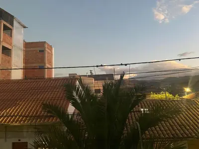 a view of the rooftop of a building with palm trees at CASA ALVAREZ in Cusco