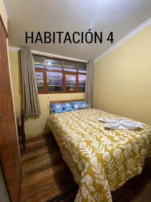 a bedroom with a bed and a window at CASA ALVAREZ in Cusco