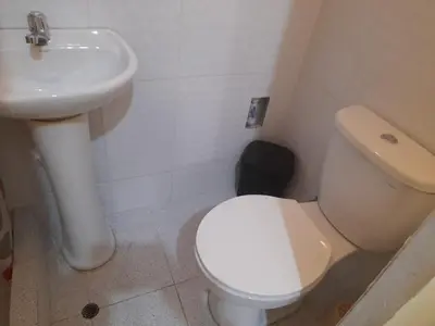 a bathroom with a white toilet and a sink at CASA ALVAREZ in Cusco