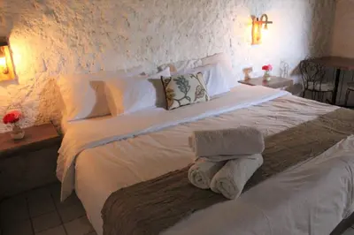 a bedroom with a white bed with towels on it at Hotel Fundo El Arrabal in Ica